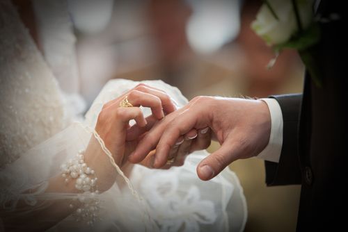 Bride Placing Ring on Groom's Hand