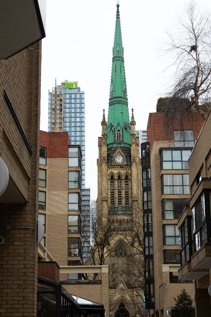toronto cathedral on a cloudy day as seen through an ally way